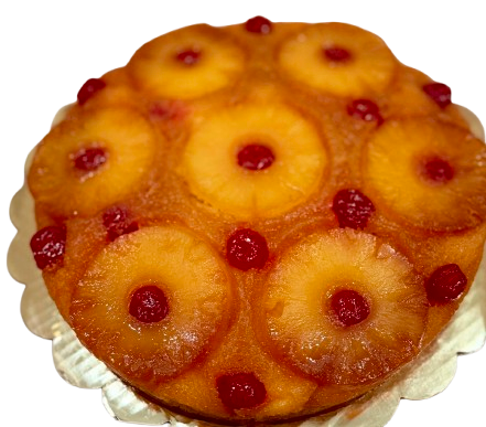A pineapple upside-down cake with cherries on top.