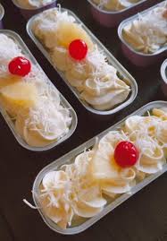 Desserts topped with whipped cream, banana slices, and cherries.