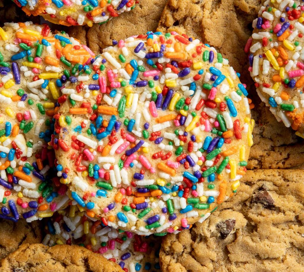 Cookies topped with colorful rainbow sprinkles.